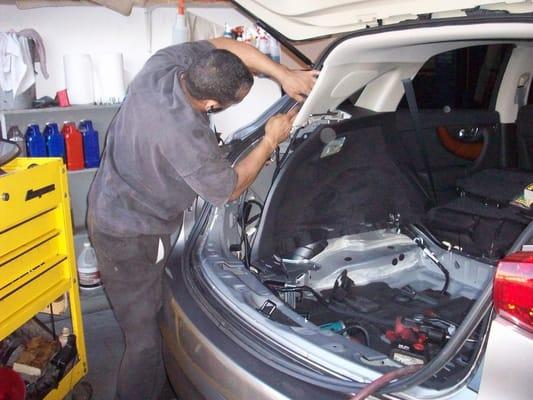 Jesus installing a trailer hitch and wiring on a 2010 Infinity FX.