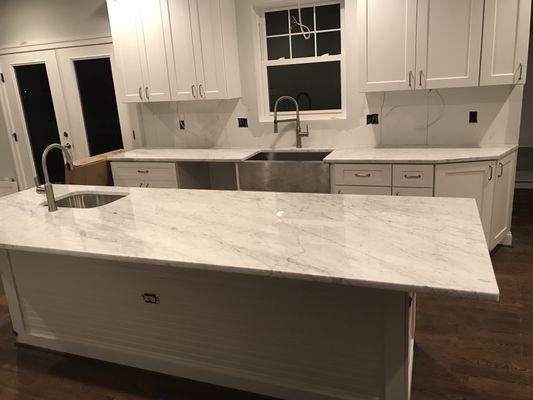 White carrera marble countertop with farm sink