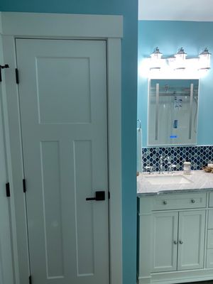 Guest bath closet and new vanity, backsplash, mirror and light.