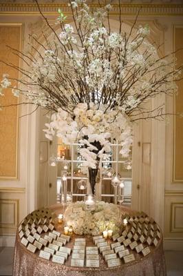 A stunning card table with blossoming Pear Branches accented with Hydrangea, cream Garden Roses and cascading white Phalaenopsis Orchids