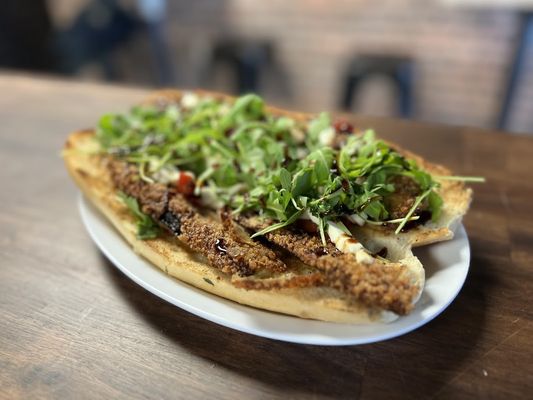 Eggplant Cutlet Hero w/ fresh mozzarella, marinated roasted red peppers, arugula, and balsamic reduction.