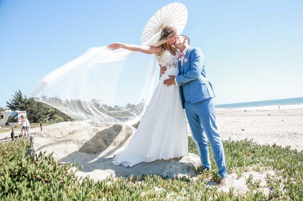 Beautiful newlywed portrait of this bride and groom with her veil in full flight!