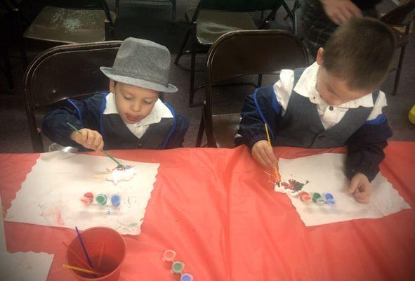 Falcon and Seamus I nanny painting their ornaments at the POMS Winter Social the mother of the kid's I nanny invited us to!