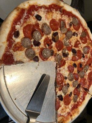 Sausage, pepperoni, olives, and garlic on a nice big pizza