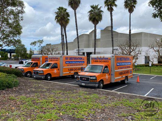 Three 911 Trucks In Front of Building