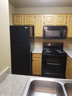 Tall fridge, built in microwave, and more beautiful counter space.