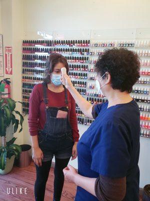 We check customers' body temperature before the service to protect everyone in the salon.