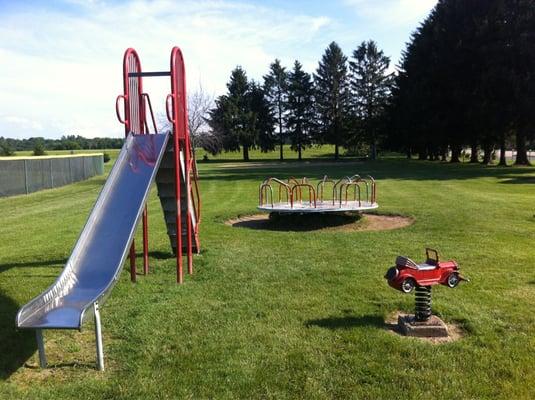 Old-style merry-go-round and a 10' metal slide