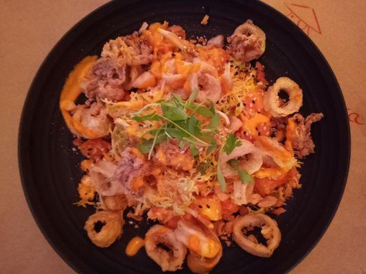 Fried Calamari Salad with Frisee, papaya chunks and chopped cashew nuts, with a hint of ginger.