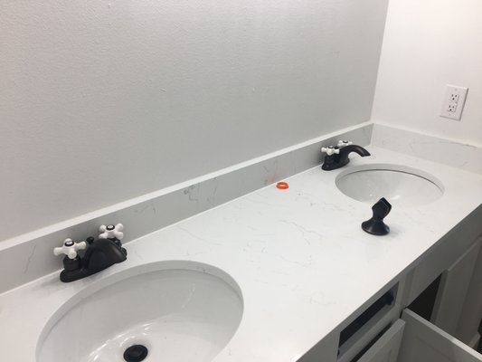 Quartz countertops in the bathroom.