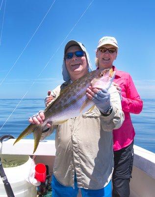 Scott and Kathy with a huge yellowtail that ate a live pilchard.