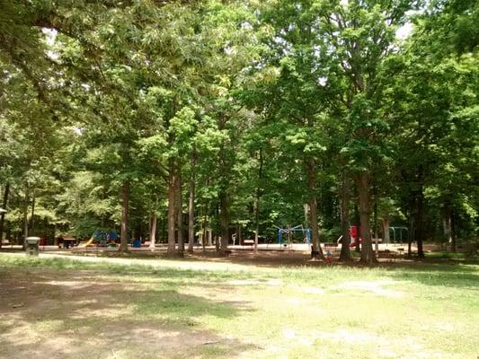 The whole playground area is shaded by lots of trees