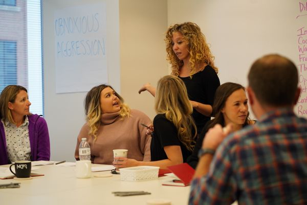 Co-founder Allison Goldberg coaches break-out groups as they practice effective communication principals.