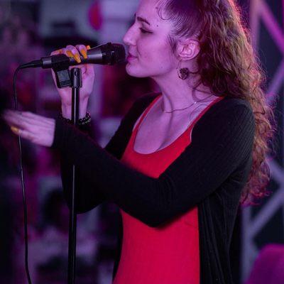 Co-Founder Leigha Rose performing at open mic night