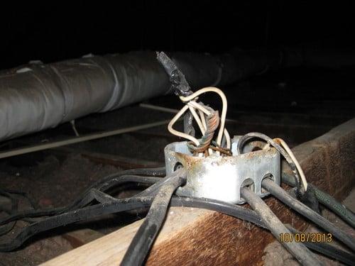 More exposed electrical wiring in the attic.