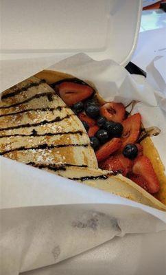 Berries crepe with powder sugar with chocolate sauce