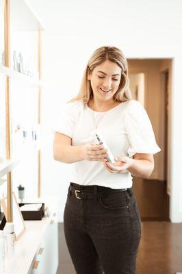 Provider, Emily Oaks, assisting a patient with kd aesthetic's medical grade skincare.