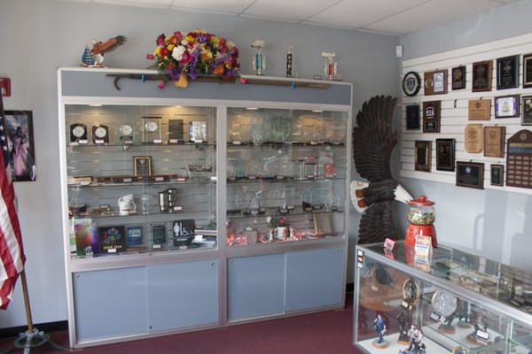 Inside our showroom, with various samples of awards we offer.