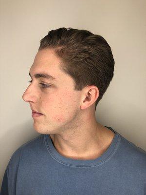 Medium length men's haircut with natural wavy textured hair.