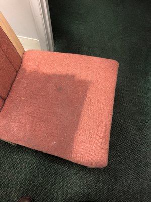 Upholstered chair being cleaned.