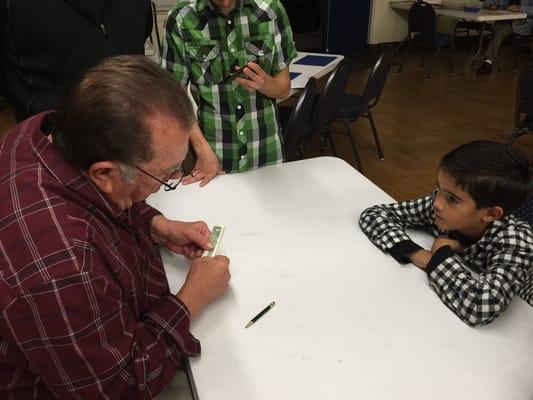 David entertaining our son with how to make a dollar ring