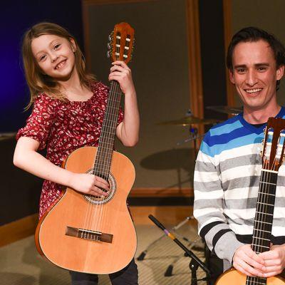 Smiling Guitar Student