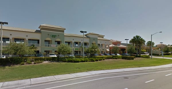 On the second floor in the front of the Quantum Village-Publix Plaza. Screenshot taken from GoogleMaps.