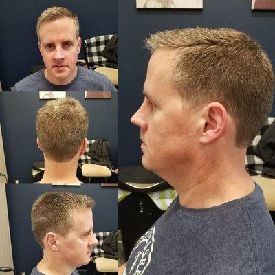 Mens fade haircut with scissors on top and a hard part