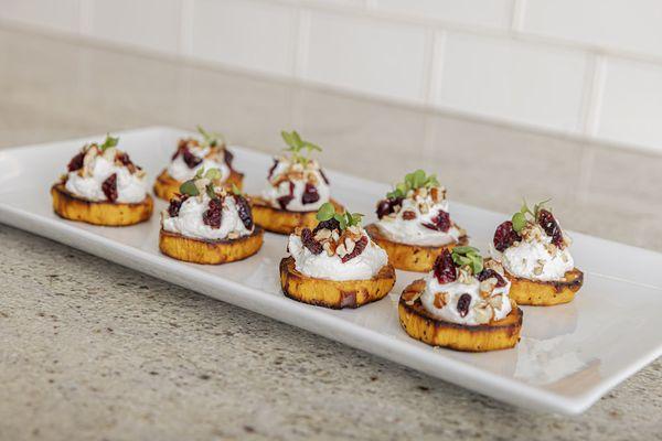 Whipped goat cheese on sweet potato rounds with walnuts & dried cherries