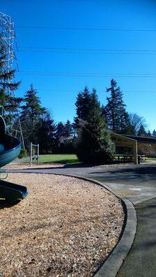 Small, sheltered picnic area. Baby swings, open space