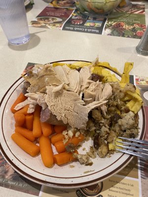 White Turkey, carrots, bread stuffing, boiled sausage, and buttered noodles, and somewhere underneath it all, homemade Mac and cheese.