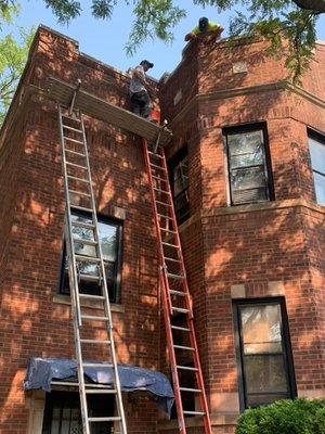 Our dedicated team, a symphony of expertise and collaboration, diligently working on a roofing project.