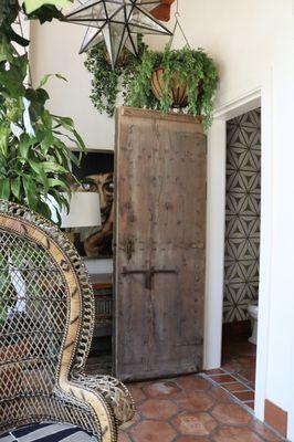 Repurposed 18th century church door. Now this door belongs to a sunroom restroom.