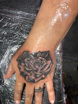 rose tattoo on hand by @wowinkboy on ig