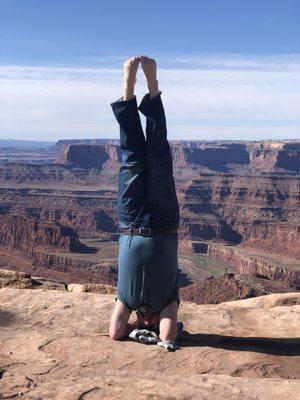 Ed, an instructor, does a headstand.