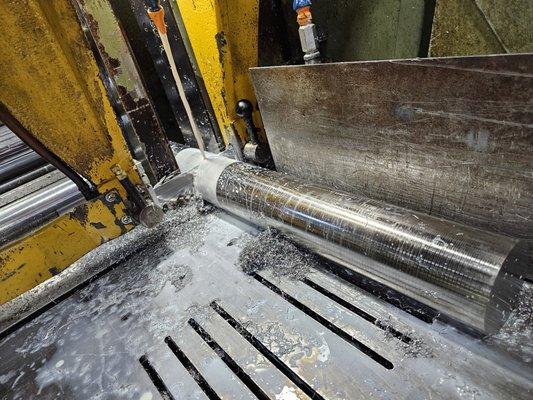 Bandsaw in action cutting material.