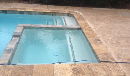 Pyette Remodel: After.   New Scabos Travertine Coping & glass accent tile on steps,