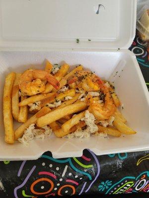 Seafood french fries, hand full of french fries, can crab meat and over cooked shrimp !