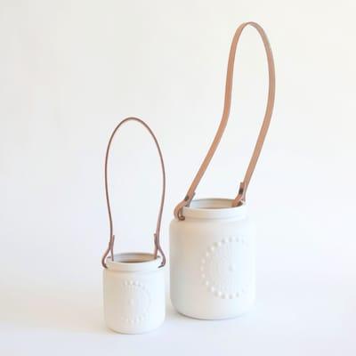 We carry beautiful ceramics from a small studio in Barcelona, like these hanging planters with leather straps.