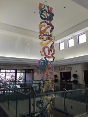 Artwork which hangs from the ceiling to the floor of this two story medical complex...