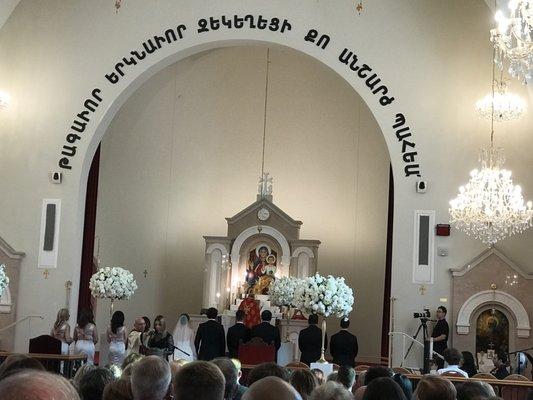 The priest blessing the newly wedded couple.