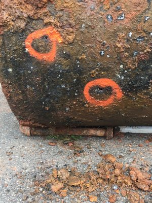 Visible signs of holes and staining on the exterior of the tank for Ben's property.