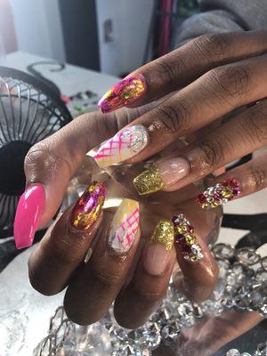 Custom design with acrylic overlay in her natural nails.