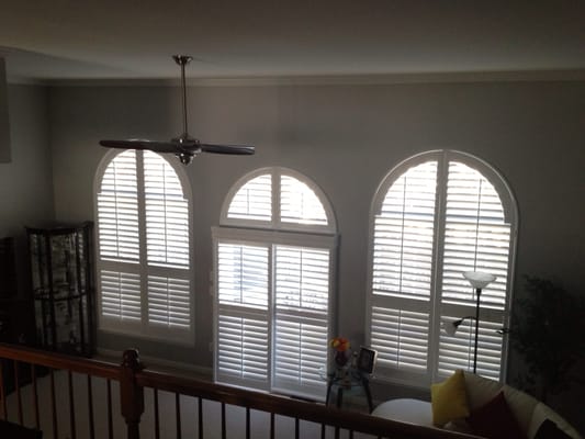 Herd is an example of arch top shutters and a bypass shutter on sliding glass door in a Leesburg Virginia home.