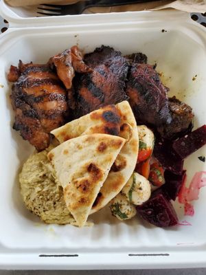 From top left clockwise: jerk chicken, mushrooms, brussel sprouts, beets, tomato mozzarella salad, pita and hummus