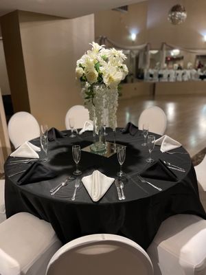 A table in large dining hall with a blurred view of dance floor