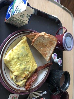 Cheese, mushroom, onion, green pepper omelette with crispy bacon and toast, milk , cocoa, and coffee. ! Absolutely delicious