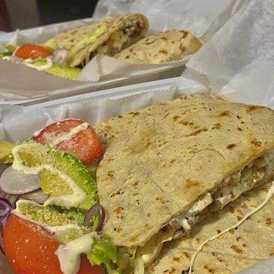 Traditional Chicken Quesadilla: Corn tortilla filled with chicken & cheese, served with lettuce, tomato, onion, sour cream, salsa