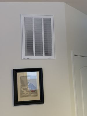 The air intake is crooked, because the wall is a bit out at the top. This is in the living room, so we get to see it every day