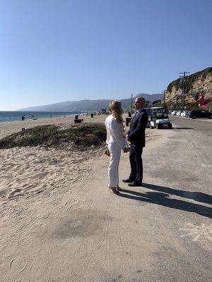 This couple enjoying there Limo ride of their wedding day at the beach